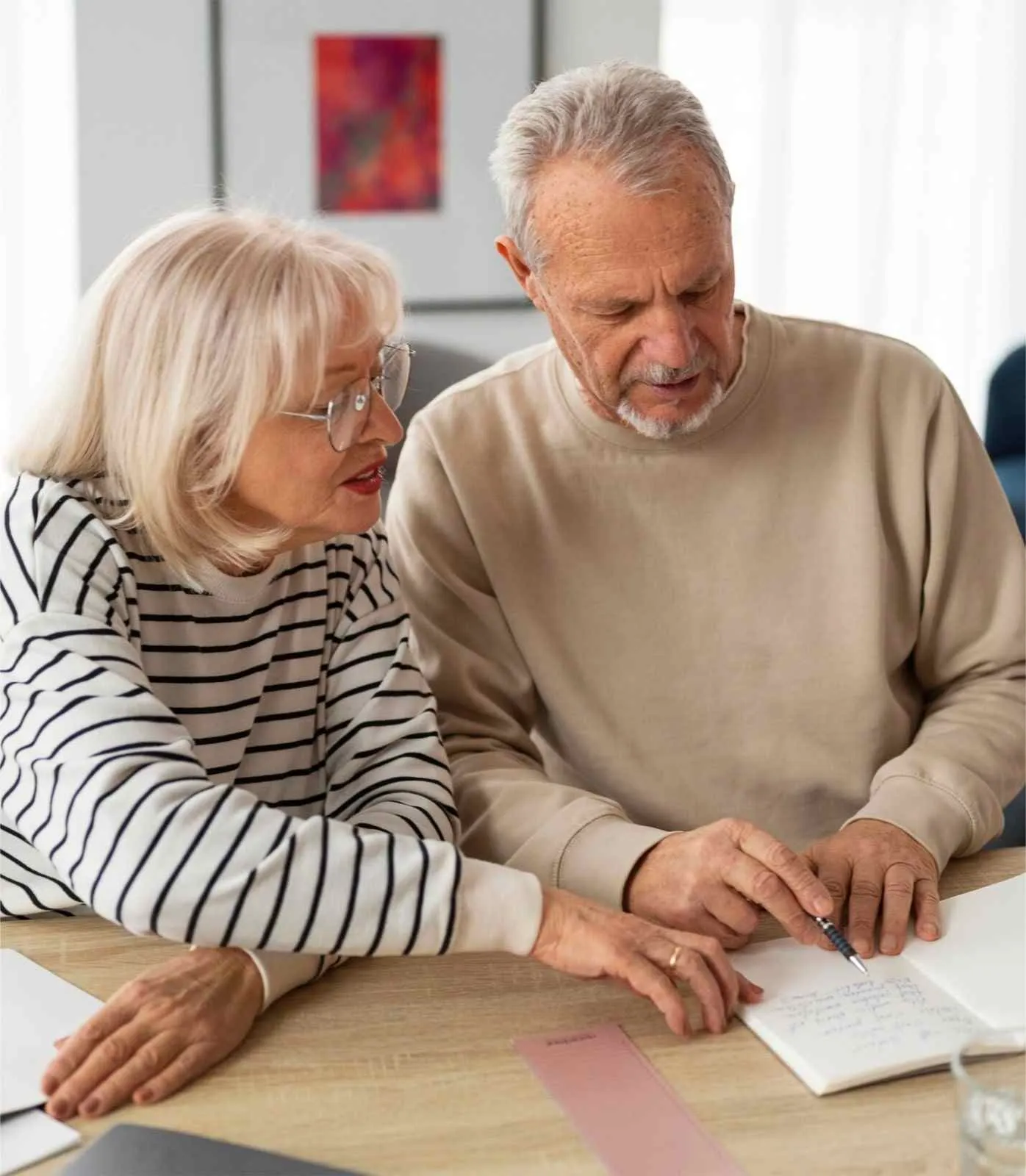 A visitor going over Medicare paperwork at a table